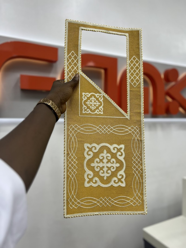 An agbada cape designed by a monogram machine at FAMK Apparel