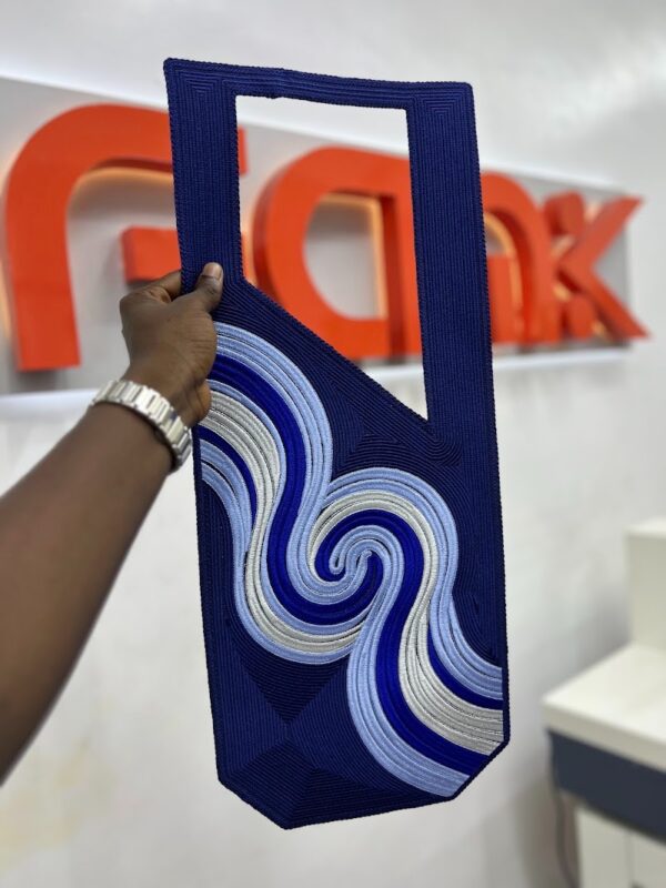 A photo of a hand holding a digital embroidery agbada cape